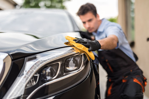 Car wash detailer cleaning a car