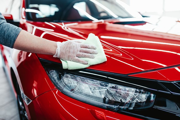 Shiny Red Car Being Wiped With Microfiber Towel